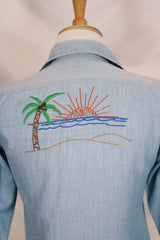 Men's or women's vintage 1970's JCPenney label long sleeve light blue chambray denim shirt with all over colored embroidery.