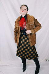 Men's or women's vintage 1970's long sleeve light brown tan colored suede jacket. Has silver snap buttons, contrast stitching, and a dagger collar.