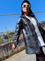 long sleeve black long leather jacket, collar and buttons up the front vintage 1960's