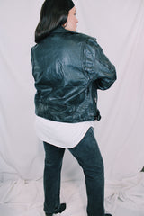 Men's or women's vintage 1980's long sleeve black leather motorcycle jacket with silver hardware. Zipper front closure and pockets.