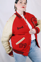Men's vintage 1987 Nelson's Jackets, Portland, Oregon label long sleeve cream and red colored varsity letterman jacket in wool and nylon material. Has patches and pins.