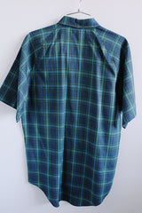 Men's vintage 1960's Penneys, Made in Japan label short sleeve button up shirt with collar in navy blue with all over blue and green plaid print.