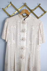 Women's vintage 1990's R & M Richards by Karen Wong label short sleeve long length duster dress in a cream satin like material. Long side slits, mandarin collar, and fabric covered buttons.