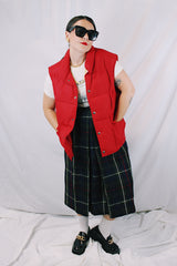Men's or women's vintage 1980's Woolrich, Made in USA label sleeveless cherry red puffer vest. Popper buttons up the front and two pockets.