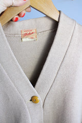Women's vintage 1960's A Genuine Dehen, The Buddy label long sleeve light tan colored button up cardigan sweater. Ribbed texture cuffs and two front pockets.