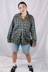 Men's or women's vintage 1970's JCPenney label long sleeve button up shirt with dagger collar in a polyester material. Brown color with all over blue print.