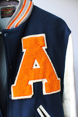 Men's vintage 1960's Skookum Letterman, Centralia Knitting Mills, Centralia Washington label long sleeve navy, white, and orange varsity letterman jacket in wool and leather material.