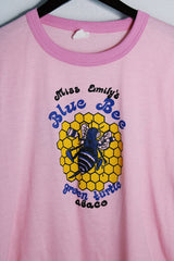 Women's vintage 1970's Chippie, Made in Bahamas label short sleeve bubblegum pink tee with a yellow and blue bee graphic on the front with a contrast trim.