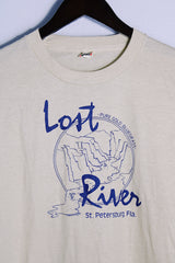 Men's or women's vintage 1980's Screen Stars, Made in USA label short sleeve light tan colored tee with blue graphic on the front in a cotton and polyester material.