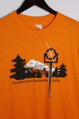 Women's or men's vintage 1980's Hanes, Fifty-Fifty, Made in USA label short sleeve orange tee with graphic on the front in black and white in a Polyester and cotton material.