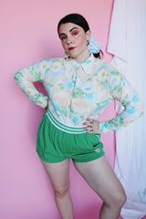 Women's vintage 1970's long sleeve button up blouse with collar in an overall yellow, green, and blue floral print. Acetate and Nylon blend material.