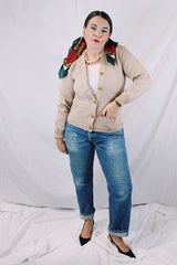 Women's vintage 1960's A Genuine Dehen, The Buddy label long sleeve light tan colored button up cardigan sweater. Ribbed texture cuffs and two front pockets.