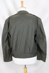 Women's or men's vintage cropped army jacket in a dark green grey wool material. Has a button closure and two front chest pockets.