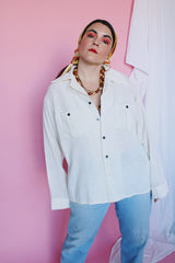 Men's or women's vintage 1970's Montgomery Ward label long sleeve cream colored cotton material button up shirt. Brown buttons and two chest pockets.