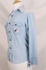 Men's or women's vintage 1970's JCPenney label long sleeve light blue chambray denim shirt with all over colored embroidery.