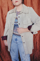 Women's or men's vintage 1970's Styled by William Barry label long sleeve grey colored suede jacket with maroon colored liner and popper buttons.