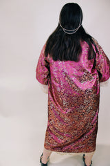 Women's vintage 1970's long sleeve long length maroon colored kimono robe jacket. Gold all over print. Front pockets and comes with matching tie belt.