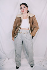 Men's or women's vintage 1970's light tan brown suede leather jacket with cream soft shearling liner. Zipper front closure and side pockets.