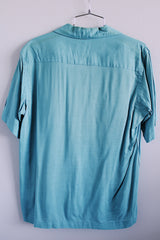 Men's vintage 1950's Skipper, Wilson Brothers, Made in USA, Custom Detailed label short sleeve blue button up shirt in cotton material with small embroidered skunks.