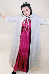 Women's vintage 1970's I. Magnin, Odette Barsa label long length short sleeve baby blue cream lace duster robe jacket with ribbon trim and peter pan collar.
