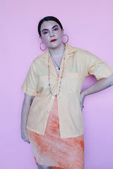 Men's or women's vintage 1960's Crystalaire, A Kentfield Exclusives short sleeve light orange colored button up shirt with two chest pockets.