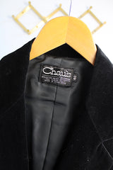 Women's vintage 1970's The Chaus Woman label long sleeve black velvet blazer in a cotton and rayon blend material. One button closure, two pockets, and fully lined.