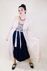 Women's vintage long sleeve long length pale pink sheer robe with an open tie front and lace trim. Has small shoulder pads and ties on cuffs.