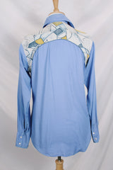 Men's vintage 1970's long sleeve button up blue colored shirt with patchwork detail throughout. Pearl snapper buttons up the front.