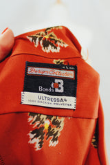 Men's or women's vintage 1970's Design Collection, Bonds label long sleeve lightweight polyester material burnt orange colored button up shirt with all over abstract floral print.