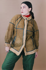 Women's vintage 1970's size medium long sleeve tan brown suede jacket with one button closure, cream fur trim, and black trim throughout.