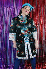 Women's vintage 1970's Bai Hua, Made in China label 3/4 arm length mid length lightweight robe jacket in black, white, blue, and an all over floral embroidered print.