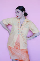 Men's or women's vintage 1960's Crystalaire, A Kentfield Exclusives short sleeve light orange colored button up shirt with two chest pockets.