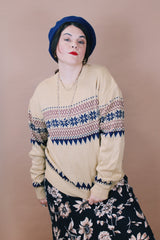 Women's or men's vintage 1980's size large long sleeve tan colored pullover sweater in an acrylic material. Navy and maroon print.