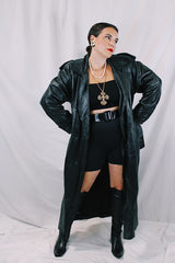 Men's or women's vintage 1980's Vakko Sport, Made in USA label long sleeve long length black leather trench coat. Double breasted closure, shoulder pads, and matching tie belt.