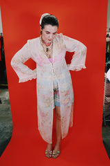 Women's vintage 1980's Valerie Stevens label long sleeve cream sheer lingerie robe with pink floral print, ruffle sleeves, and a tree button closure.