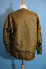 Men's or women's vintage 1950's long sleeve reversible army liner jacket. One side is a nubby cream color and one side is green Nylon.