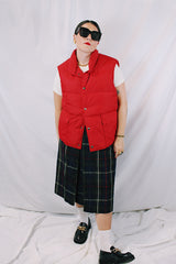 Men's or women's vintage 1980's Woolrich, Made in USA label sleeveless cherry red puffer vest. Popper buttons up the front and two pockets.