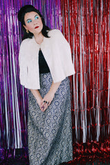 Women's vintage 1970's short length white furry faux fur white poncho sweater. Has button closure in the front and slits for arms