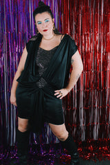 Women's vintage 1980's Stash label sleeveless mini length black dress with bronze metallic details.