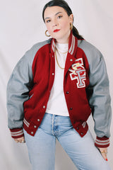 Men's or women's vintage 1980's DeLong, Made in USA label long sleeve dark red and grey varsity letterman jacket with patches and pins. Wool and leather material.