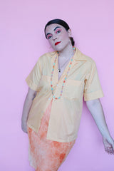Men's or women's vintage 1960's Crystalaire, A Kentfield Exclusives short sleeve light orange colored button up shirt with two chest pockets.