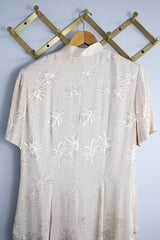 Women's vintage 1990's R & M Richards by Karen Wong label short sleeve long length duster dress in a cream satin like material. Long side slits, mandarin collar, and fabric covered buttons.