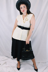 Women's vintage 1970's Montgomery Ward sleeveless button up sweater vest cardigan in a cream white color. Acrylic material and all over cable knit texture.