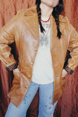 Women's or men's vintage 1970's Lou Pollack, Made in Spain label long sleeve long length tan camel brown colored leather blazer jacket with tortoise buttons up the front.