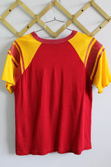 Women's or men's vintage 1970's Champion, Made in USA labels short sleeve sport jersey in maroon red and mustard yellow with USC graphic on the front and stripes on the sleeves.