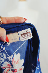 Men's or women's vintage 1970's Montgomery Ward label shiny vibrant navy blue button up shirt with dagger collar and all over floral print.