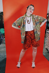 Women's or men's vintage 1960's Don Soper of California label short sleeve button up shirt with collar. All over paisley print in green, yellow, and orange.