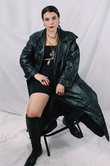 Men's or women's vintage 1980's Vakko Sport, Made in USA label long sleeve long length black leather trench coat. Double breasted closure, shoulder pads, and matching tie belt.