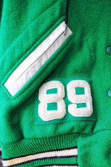 Women's vintage 1989 Nelson's Jacket, Portland, Oregon label bright green wool varsity letterman jacket with white trim. Has snap buttons, patches, pockets, and a hood. Shop more vintage outerwear and sportswear at Live Forever Vintage.