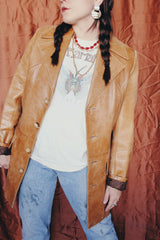 Women's or men's vintage 1970's Lou Pollack, Made in Spain label long sleeve long length tan camel brown colored leather blazer jacket with tortoise buttons up the front.